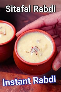 two red bowls filled with food sitting on top of a wooden table next to each other