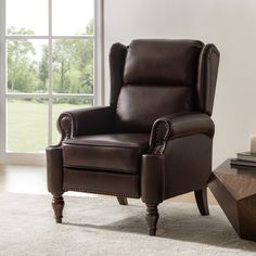 a brown leather recliner chair sitting in front of a window