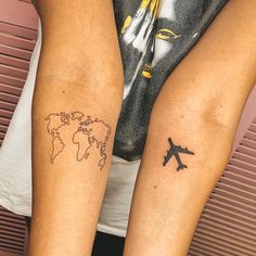 two people with tattoos on their legs that have an airplane and world map tattooed on them