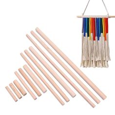 a group of wooden dows with different colored sticks hanging from the top and bottom