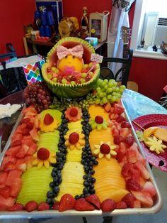 a tray filled with fruits and vegetables on top of a table