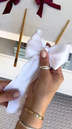 a woman is holding two matches in her hand and tied up with a white bow