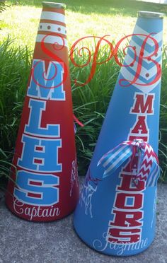 two red, white and blue vases sitting on the ground next to each other