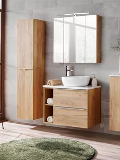 a bathroom with a sink, mirror and rug on the floor in front of it