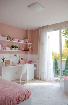 a bedroom with pink walls and white furniture