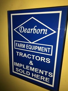 a sign on the wall that says dearborn farm equipment tractors and implements sold here