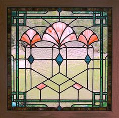 a stained glass window in a wooden frame