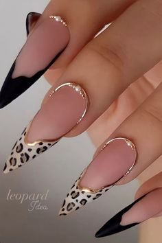 a woman's nails with leopard print and black stilts on them, including gold accents