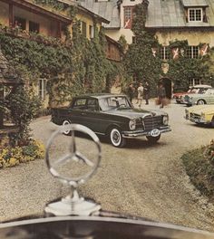 an old car parked in front of a house