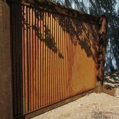 the shadow of a tree is cast on an iron fence