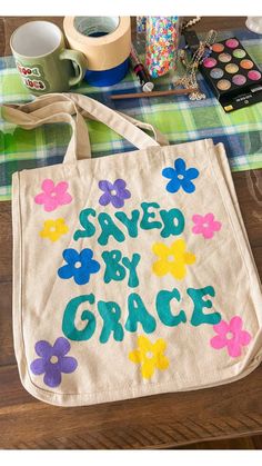 a bag that says saved by grace with flowers on it and other crafting supplies