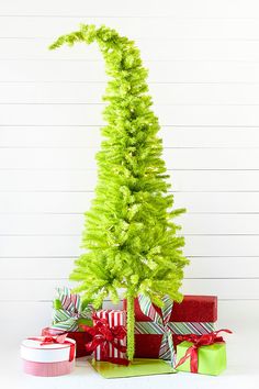 a green christmas tree with presents under it