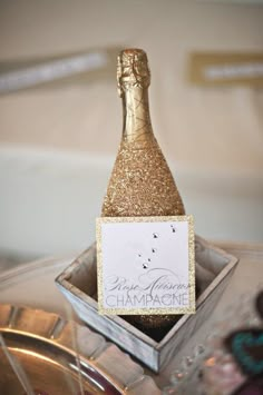 a bottle of champagne sitting on top of a table