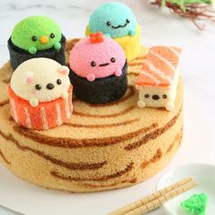 there is a cake decorated with different kinds of sushi