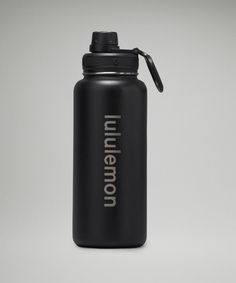 a black water bottle with the word'unimendo'printed on it, sitting in front of a gray background