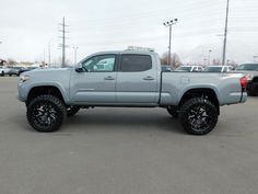 a silver truck parked in a parking lot