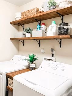 a washer and dryer sitting next to each other in a room with open shelving