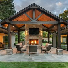 an outdoor living area with fireplace and seating