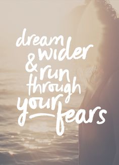 a person standing in front of water with the words dream and fear through their eyes