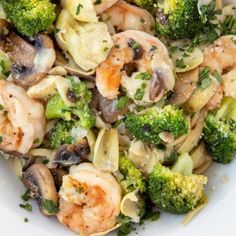 pasta with shrimp, mushrooms and broccoli in a white bowl