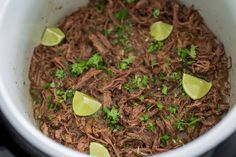 shredded beef with cilantro and limes in a slow cooker