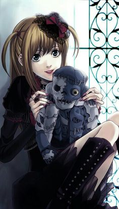 a girl holding a stuffed animal in her arms with skulls on it's chest