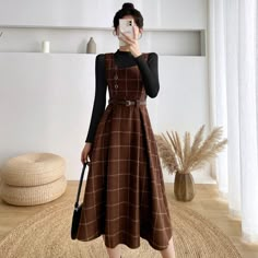 Knit plaid midi dress with thick shoulder straps, sweetheart neckline, side button details and belted waist. Structured pleated skirt with side cutouts. Concealed back zipper. Layer it with the Basic Turtleneck Sweater. S: 26" waist, 41" lengthM: 27.5" waist, 41" lengthL: 29" waist, 41" lengthXL: 30.5" waist, 41" length Vintage Core Outfits, Pinafore Outfit, Dark Academia Dresses, Dark Academia Dress, Academia Wardrobe, Victorian Skirt, Preppy Mode, Teacher Aesthetic, Woolen Dresses