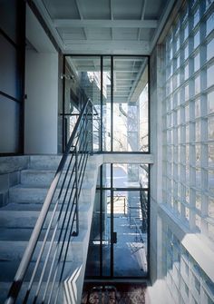 the stairs are made of glass blocks and lead up to an upper level balcony area