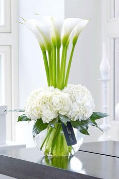 a glass vase with white flowers in it