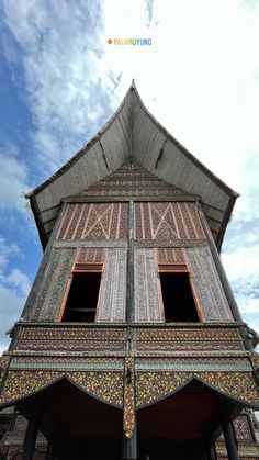 an old wooden building with two windows