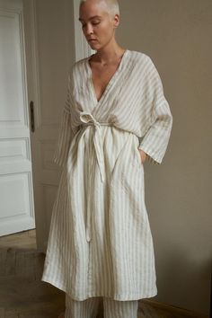 Linen robe designed for lounging routines. In full length, ¾ length dropped sleeves, and side seam pockets. Features a classic V-neck, and separate belt to delicately hug the body. This robe is crafted from natural and lightweight linen to ensure a breathable and soft experience. Cut in a relaxed shape, perfect to snuggle up with a morning coffee. SIZING AND FIT This garment is oversized. If you want to wear this piece as close-fitting, select a smaller size than you usually wear. Before placing Striped Long Sleeve Robe For Loungewear, Linen Bathrobe, Linen Robe, Wrinkle Remover, Pajama Robe, Womens Robes, Hot Weather, Style Expert, Grey Stripes