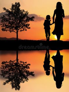 a mother and child holding hands as the sun sets