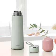 thermos and vases are sitting next to each other