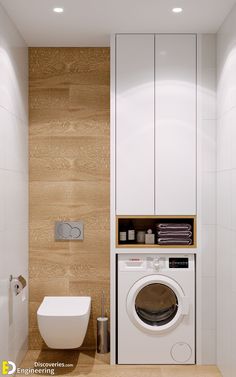 a washer and dryer in a bathroom with wood paneling on the walls