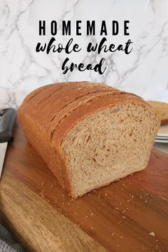 a loaf of bread sitting on top of a wooden cutting board next to a knife