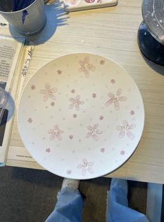 a white plate sitting on top of a wooden table