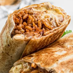 two burritos with meat and cheese on them