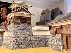 an image of a model of a man in front of a castle with his face on the wall