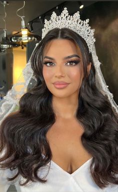 a woman wearing a wedding veil and tiara