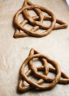 two pretzels sitting on top of a table next to each other