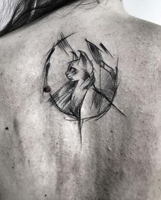 the back of a woman's shoulder with a black and white tattoo design on it