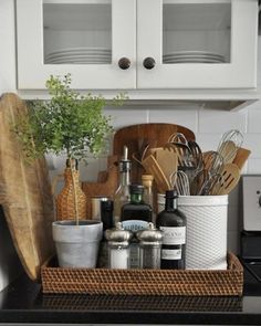 kitchen utensils and bottles are sitting on the counter