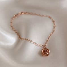 The classic English rose says it all. Whether for a special gift or a special occasion, this pretty and feminine rose gold Rose Bracelet will make a statement that everyone understands. The Rose symbolises love, promise, hope and new beginnings making it a popular choice for wedding jewellery. This dainty bracelet makes a meaningful birthday gift and is perfect for bridesmaid's jewellery. ~ DESIGN ~ This delicate chain bracelet features a rose gold plated or 14k rose gold filled Rose charm set o Personalized Elegant Rose-colored Jewelry, Elegant Rose Gold Bracelets With Flower Charm, Elegant Rose Gold Bracelet With Flower Charm, Elegant Personalized Rose Jewelry, Elegant Personalized Rose-colored Jewelry, Formal Rose Gold Flower Bracelet, Elegant Rose Gold Charm Bracelet For Wedding, Elegant Rose Colored Bracelet Jewelry, Elegant Rose-colored Bracelet Jewelry