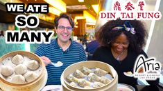 a man and woman standing in front of some dumplings