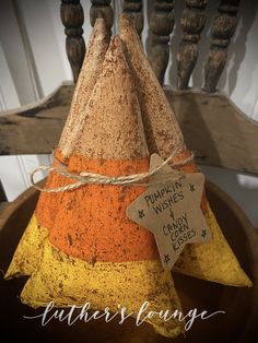 an orange and yellow cone with a tag on it