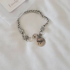 a silver bracelet with two charms on it