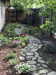 a stone path in the middle of a garden