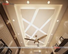 a ceiling fan mounted to the ceiling in a room with white walls and flooring