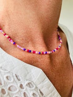 Beautiful beaded necklace that has seven shades of pink, two shades of purple and a bit of silver and gold. for all ages and genders. Purple Choker With Colorful Beads For Gift, Pink Beaded Amethyst Necklace, Playful Adjustable Purple Necklace, Violet Necklace Flower, Violet Necklace, Beautiful Beaded Necklaces, Gold Bead Necklace, Gorgeous Necklaces, Shades Of Purple