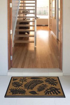 an open door leading to a living room with stairs